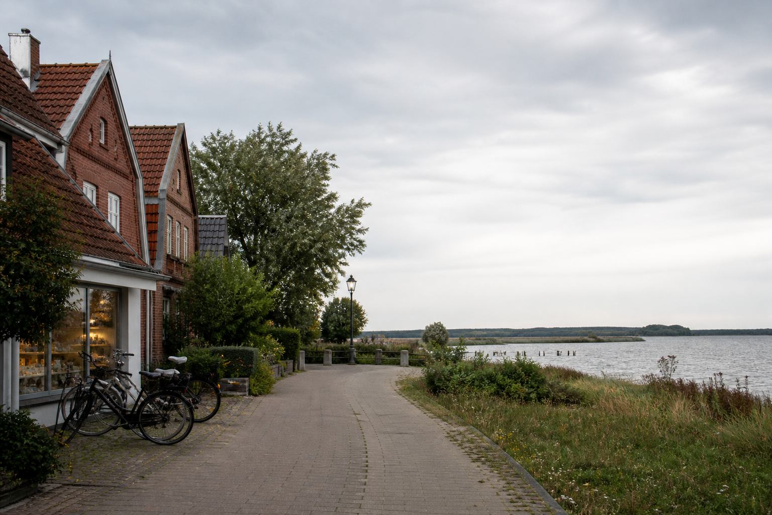 Brick lakeside houses and bicycles along a quiet north German waterfront